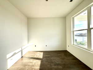 Empty room with dark wood-type flooring