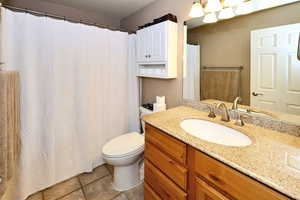 Bathroom with tile patterned flooring, toilet, and vanity