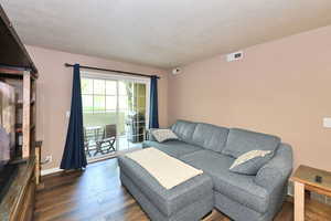 Living room with dark hardwood / wood-style floors