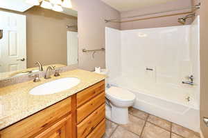 Full bathroom featuring shower / washtub combination, tile patterned floors, toilet, and vanity