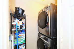 Laundry room featuring stacked washer / drying machine