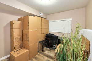 Office area with light wood-type flooring