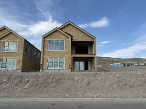 View of home featuring a mountain view and a balcony