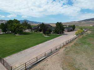 Exterior space with a rural view, a lawn, and a mountain view