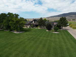 Exterior space with a mountain view and a front yard