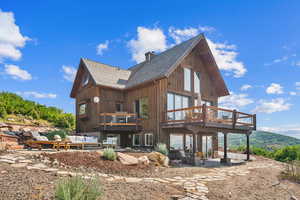 Back of property featuring a patio and an outdoor hangout area