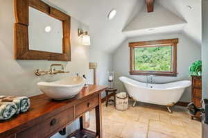 Bathroom with a bath, vanity, tile patterned flooring, and vaulted ceiling with beams