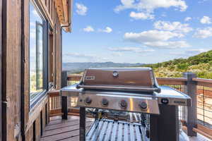 Deck featuring a mountain view and a grill