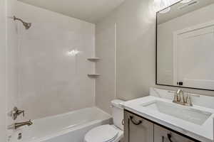 Full bathroom featuring vanity,  shower combination, and toilet