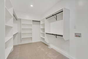 Walk in closet featuring carpet flooring