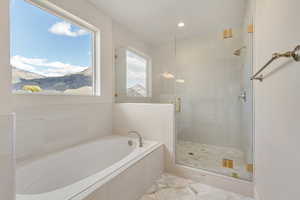 Bathroom with a mountain view, tile patterned flooring, and independent shower and bath