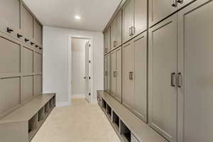 Mudroom featuring light carpet