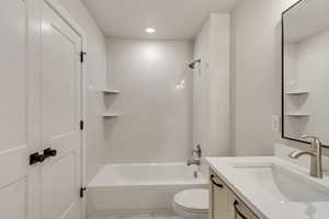 Full bathroom featuring washtub / shower combination, vanity, and toilet