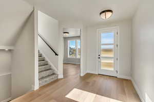 Entrance foyer featuring light hardwood / wood-style floors