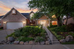 View of front of home featuring a garage and solar panels