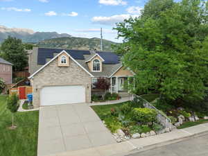 View of front of house featuring a mountain view and solar panels