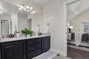 Bathroom featuring vanity and vaulted ceiling