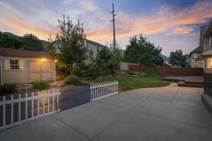 Patio terrace at dusk with a deck and a yard