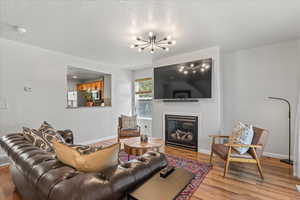 Bright and welcoming entry and living room with updated light fixture.