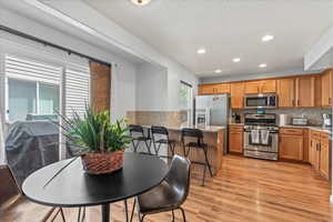 Kitchen with Breakfast bar and stainless steel appliances including a gas stove.