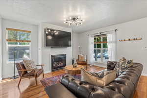 Bright and welcoming entry and living room with updated light fixture.