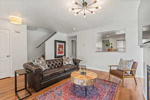 Bright and welcoming entry and living room with updated light fixture.