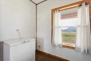 Clothes washing area featuring a mountain view and dark carpet