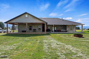 Back of house featuring a patio and a lawn