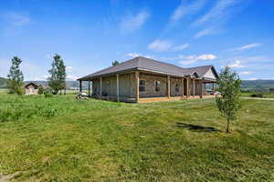 Rear view of property featuring a patio and a lawn