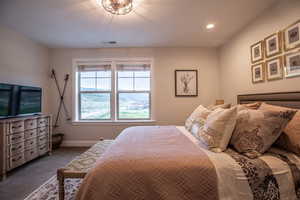 Bedroom featuring dark carpet