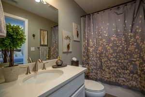 Bathroom with tile patterned floors, toilet, and vanity