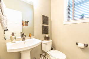 Bathroom featuring sink and toilet