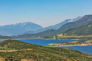 Property view of mountains featuring a water view