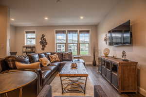 Living room with dark hardwood / wood-style flooring