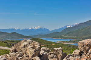 Property view of mountains with a water view