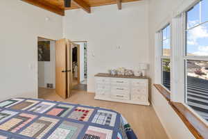 Bedroom with beamed ceiling, wooden ceiling, and light wood-type flooring