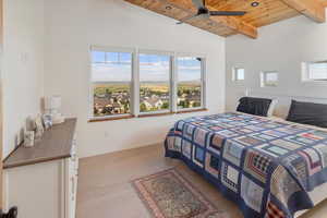 Bedroom with ceiling fan, hardwood / wood-style flooring, vaulted ceiling with beams, and wood ceiling
