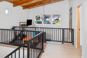 Interior space featuring light hardwood / wood-style floors, lofted ceiling with beams, plenty of natural light, and wood ceiling