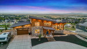 View of front facade featuring a garage and a mountain view