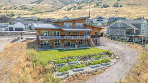 Rear view of property with a patio and a yard
