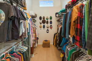 Spacious closet featuring hardwood / wood-style floors