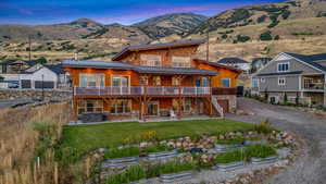 Exterior space featuring a patio, a yard, and a mountain view