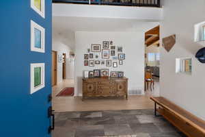 Hall featuring beamed ceiling and hard wood flooring