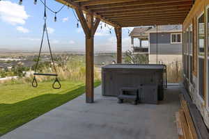 View of patio featuring a hot tub