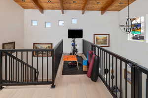 Interior space with beamed ceiling, light hardwood / wood-style floors, and wooden ceiling