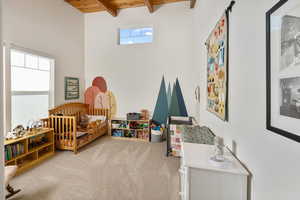 Game room featuring carpet and beam ceiling