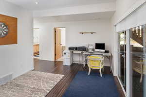 Office area with dark hardwood / wood-style floors