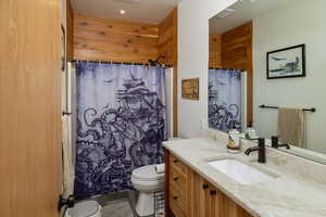 Bathroom featuring tile patterned flooring, toilet, and vanity
