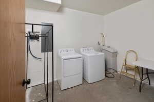 Basement laundry room  featuring washer and clothes dryer