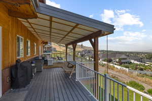 Wooden terrace with outdoor lounge area, a yard, and area for grilling